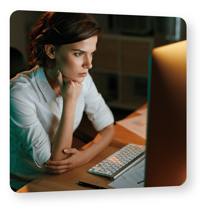 Woman looking at computer resting head on hand
