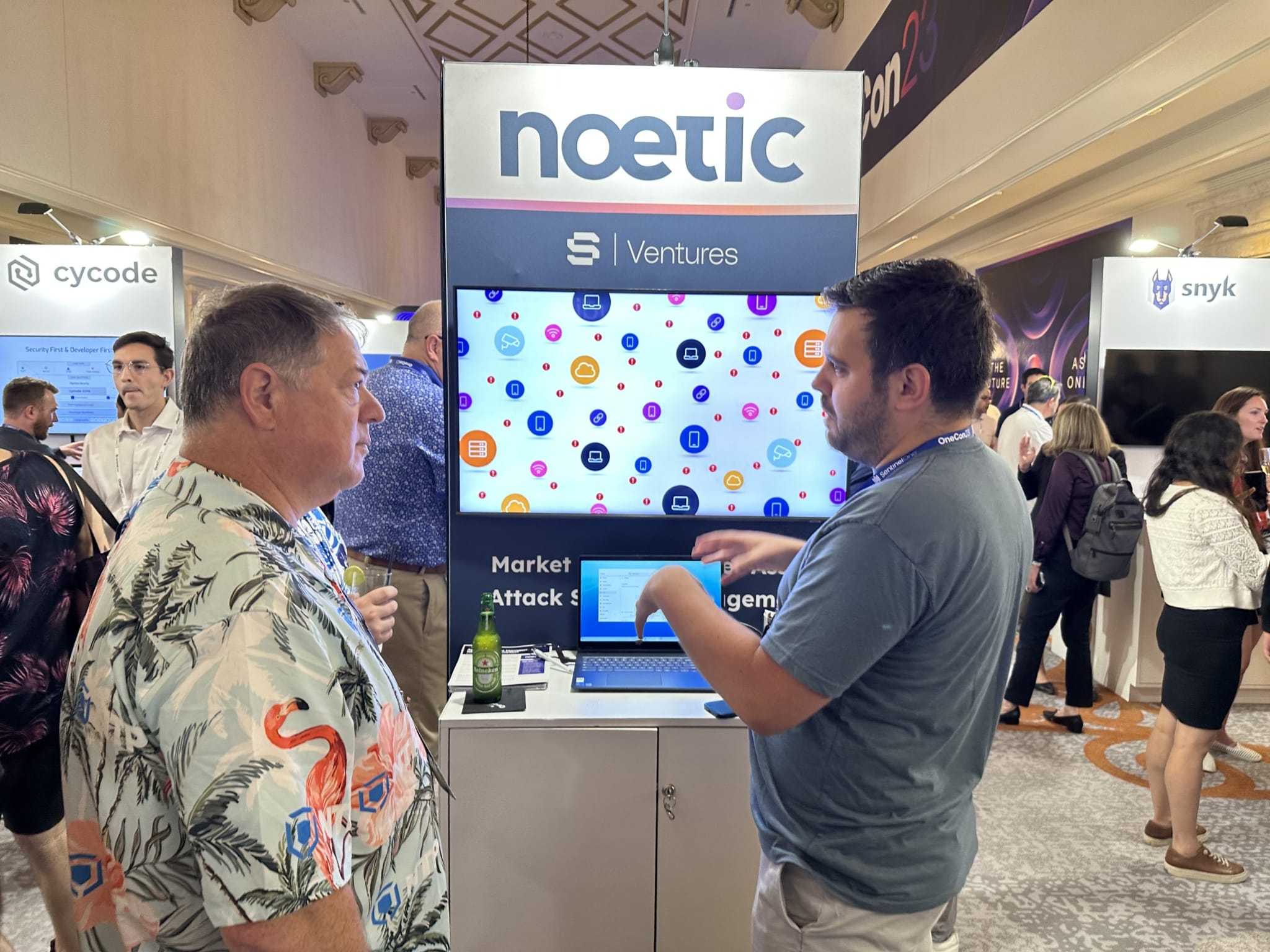 Craig Roberts presenting Noetic to an attendee at OneCon