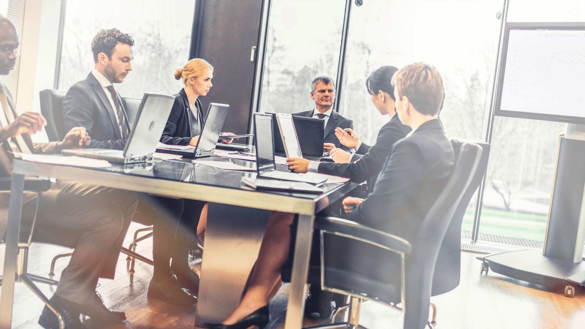 a group of business people sitting at a conference table
